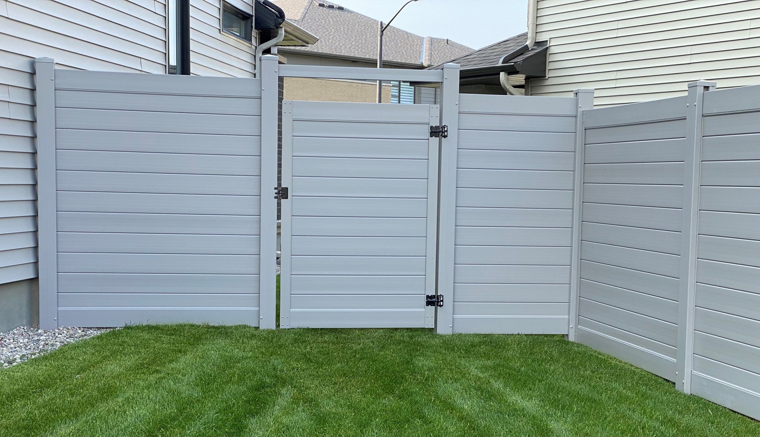 Grey horizontal PVC fence by Williamsburg Woods and Garden, Ontario