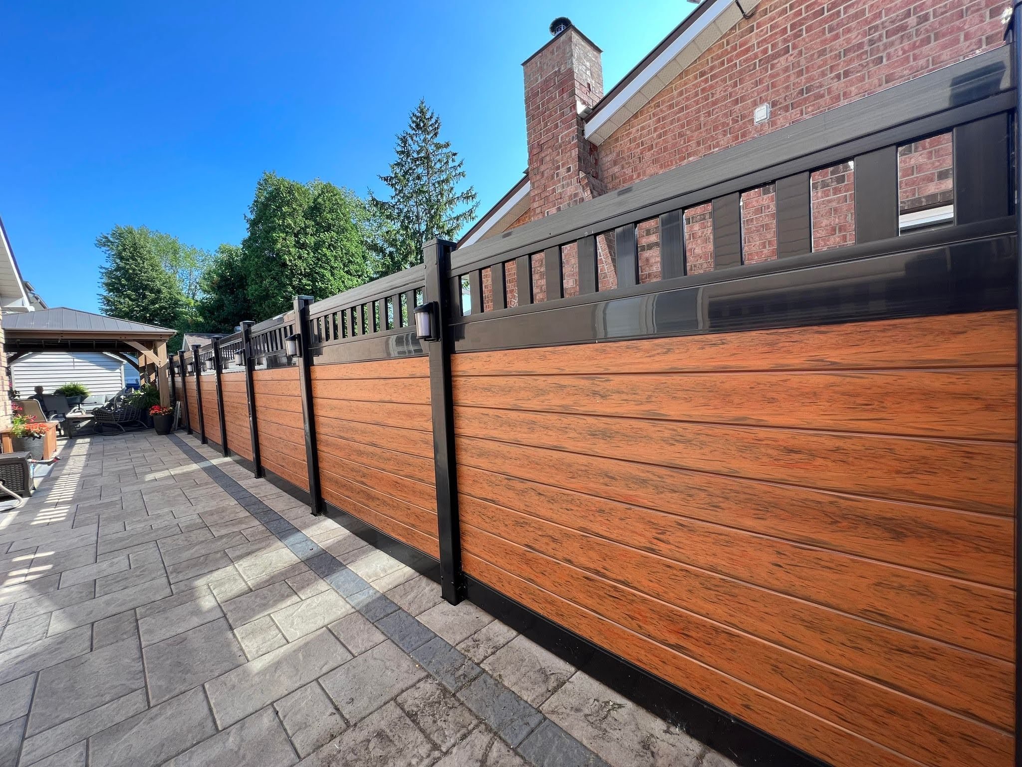 Lava and black PVC fence installed by Williamsburg Woods and Garden, Eastern Ontario