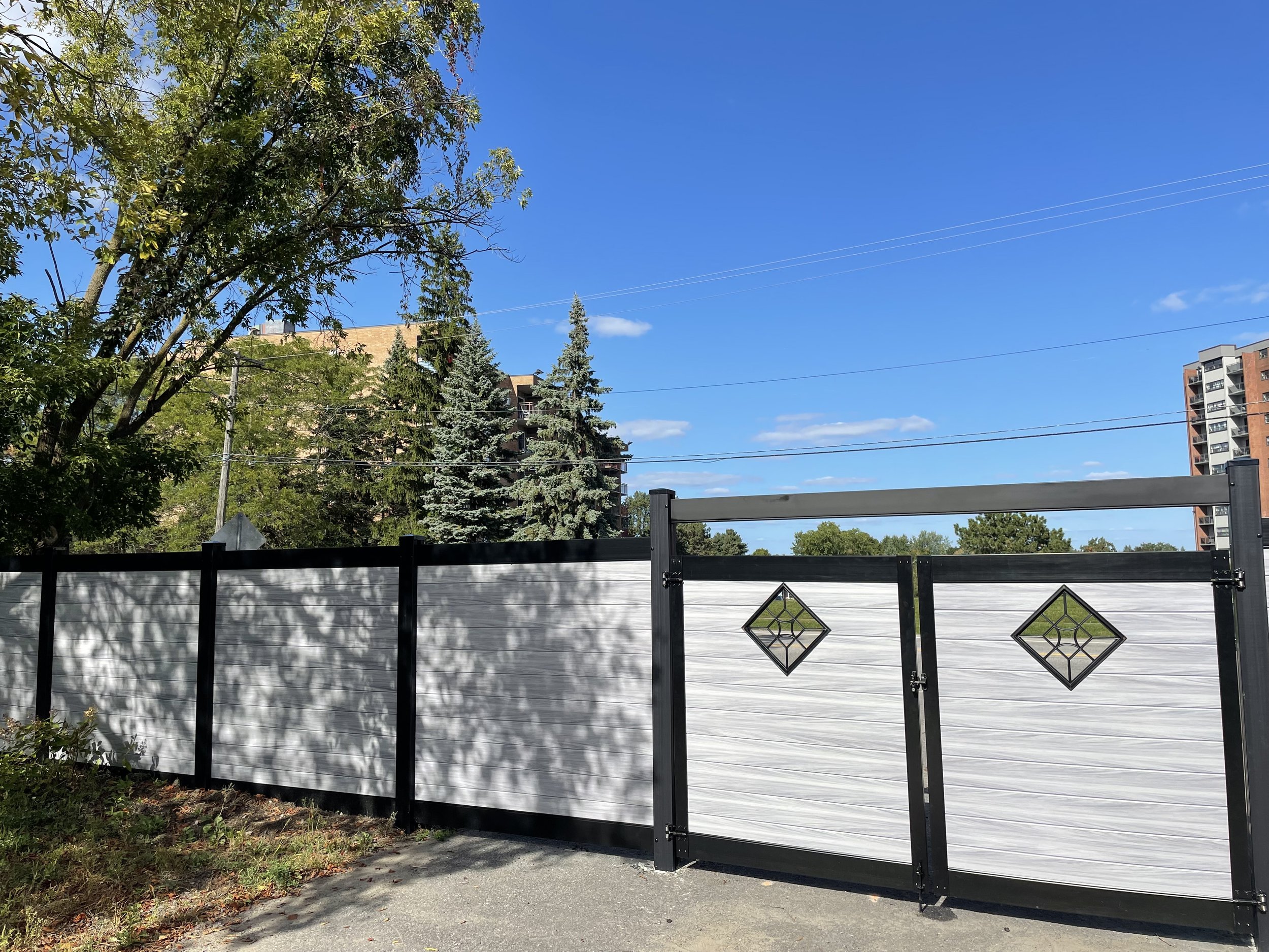 Grey PVC double gate fitted by Williamsburg Woods and Garden, Ontario