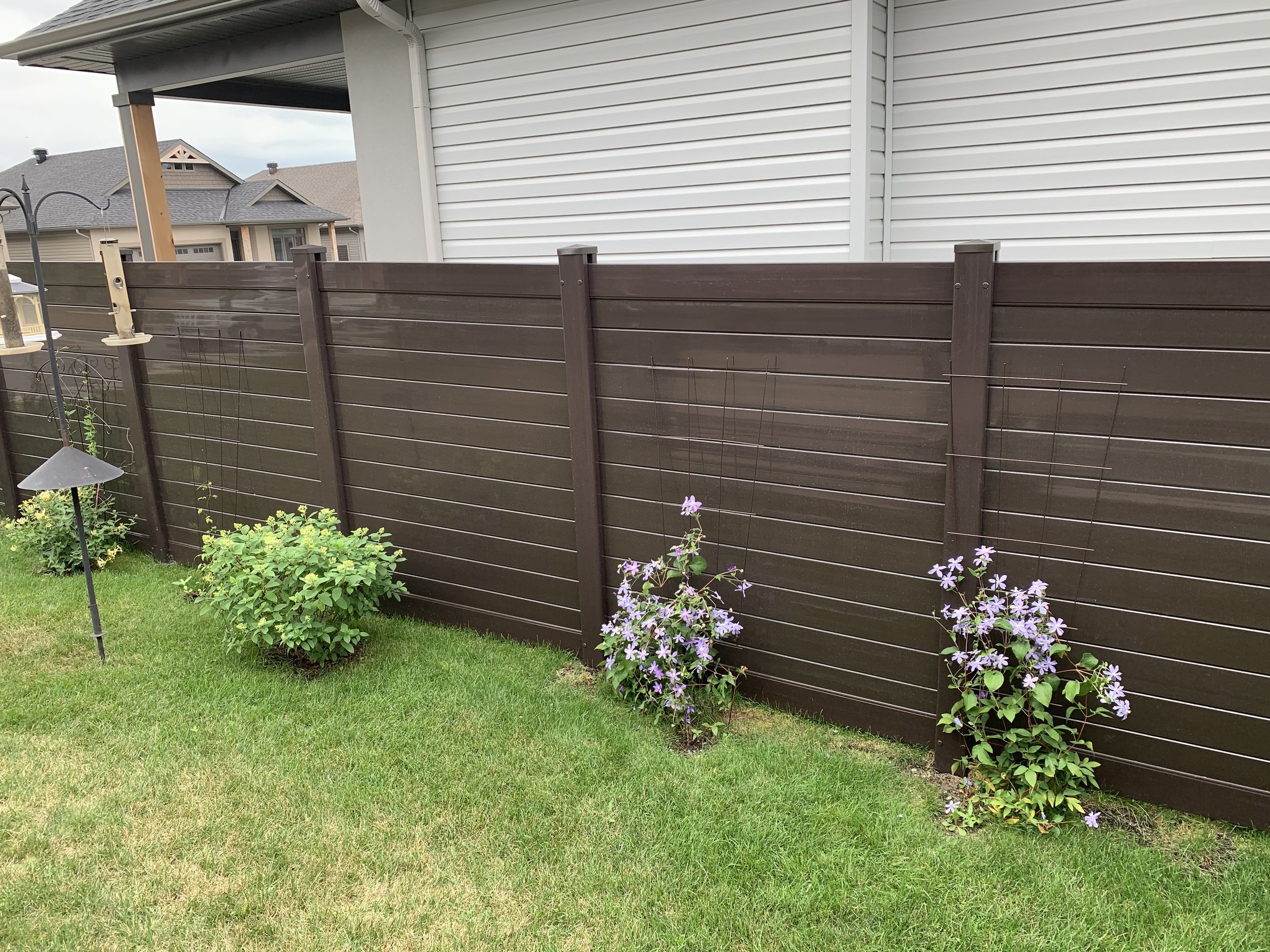 Acorn brown horizontal PVC fence installation in Eastern Ontario by Williamsburg Woods and Garden